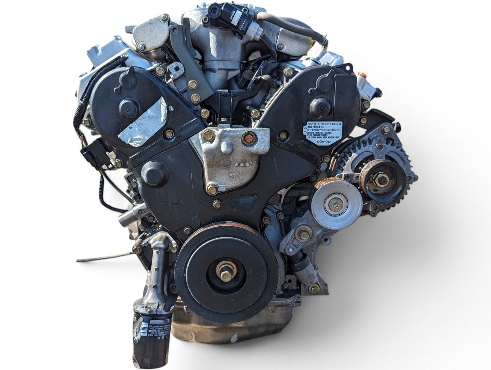 Front of a JDM Honda J30A 3.0L V6 engine showing the timing belt covers and accessory pulleys
